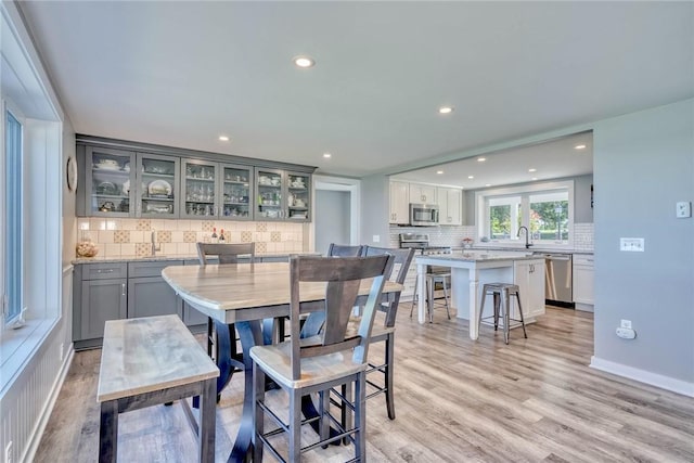 dining space featuring light wood-type flooring and recessed lighting