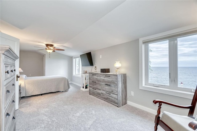 bedroom featuring baseboards, a ceiling fan, vaulted ceiling, and light carpet