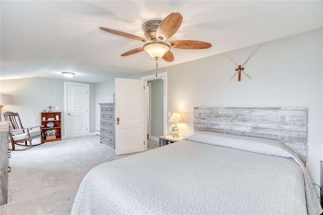 bedroom featuring light colored carpet, ceiling fan, and vaulted ceiling