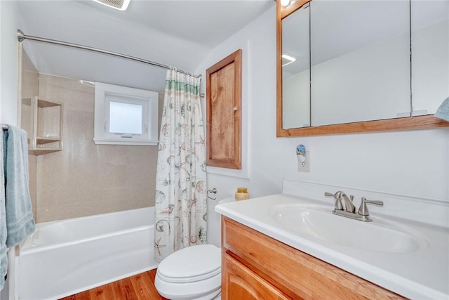 full bath featuring vanity, toilet, wood finished floors, and shower / bath combination with curtain