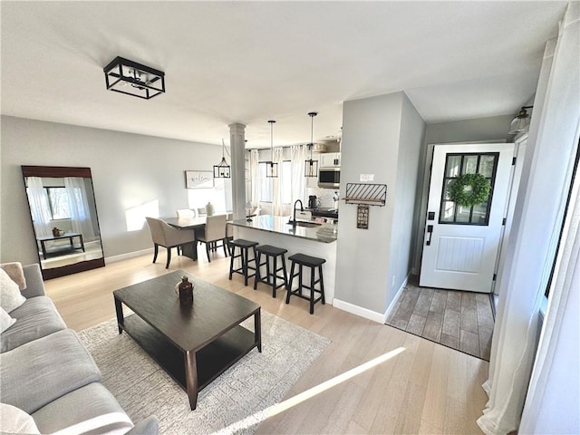 living area with light wood-style floors and baseboards