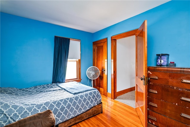 bedroom with baseboards and light wood-style flooring