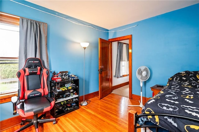 bedroom with baseboards and wood finished floors