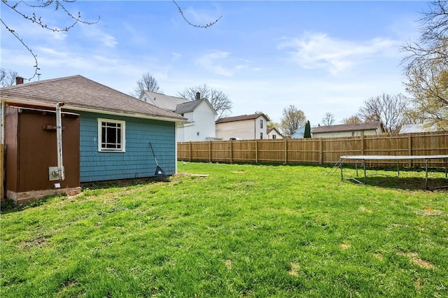 view of yard featuring a fenced backyard and a trampoline