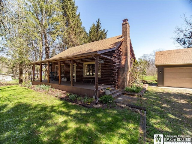 exterior space with a chimney, a porch, a front yard, and log siding