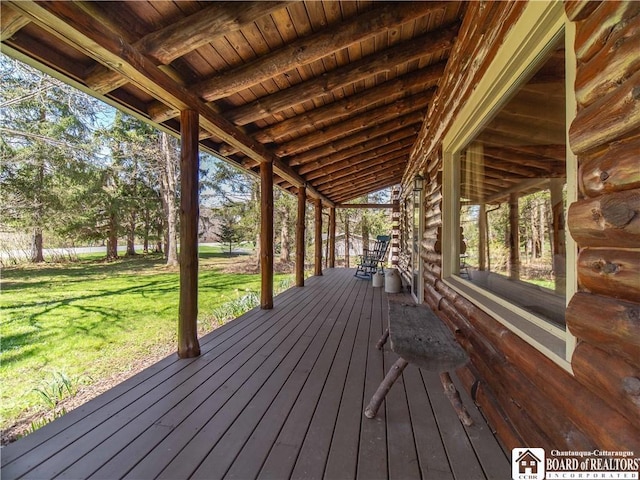 wooden deck featuring a yard