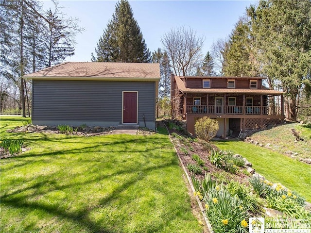 back of property featuring a lawn