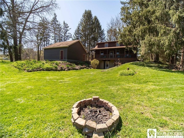 view of yard with an outdoor fire pit and a deck