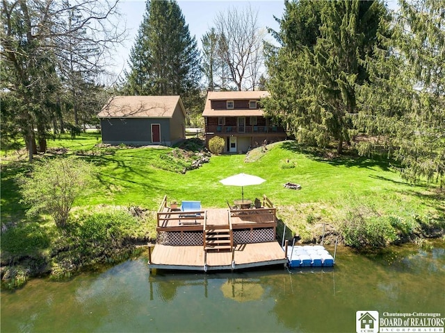 dock area featuring a yard and a deck with water view