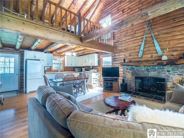 living area with light wood-type flooring, wood ceiling, high vaulted ceiling, and beamed ceiling