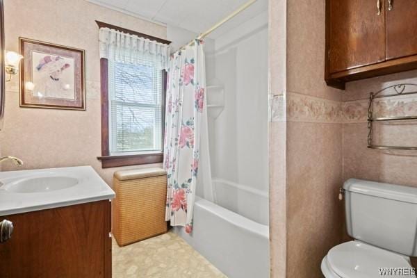 full bathroom with vanity, shower / bath combination with curtain, and toilet