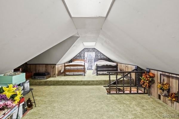 interior space featuring carpet flooring and vaulted ceiling
