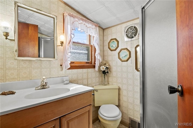404 72nd St, Niagara Falls, NY 14304 - bathroom featuring a shower stall, vanity, toilet, and tile walls