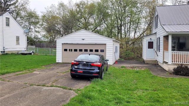 detached garage featuring fence