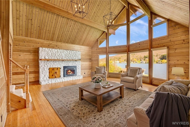 256 W Shore Rd, Cuba, NY 14727 - living room featuring an inviting chandelier, wood walls, a wealth of natural light, and high vaulted ceiling
