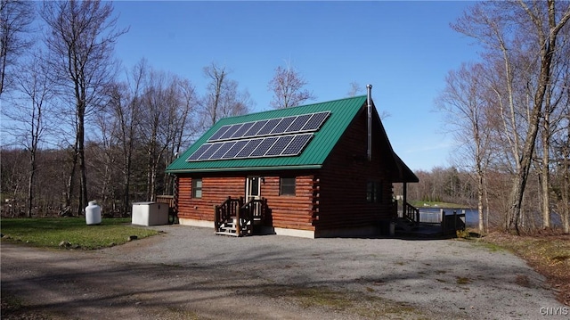 view of outbuilding featuring solar panels