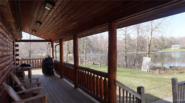 wooden terrace featuring a lawn, a water view, and area for grilling