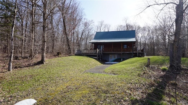 view of yard featuring a deck and a forest view