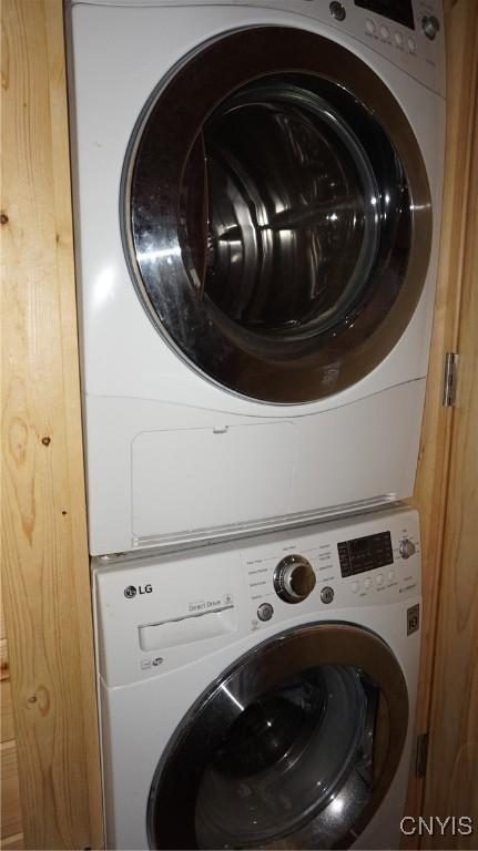 washroom featuring laundry area and stacked washer / dryer