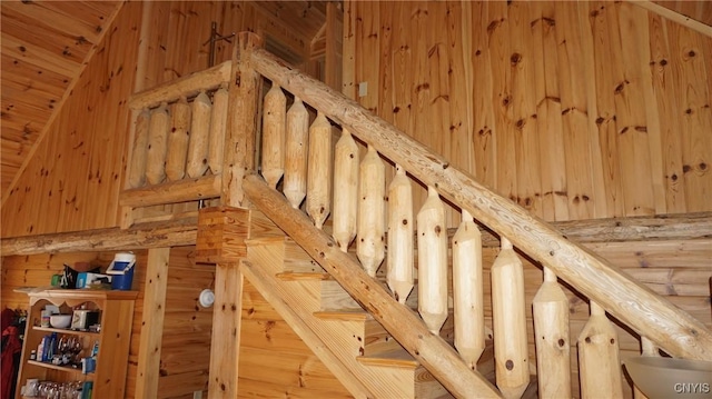 staircase with wood walls