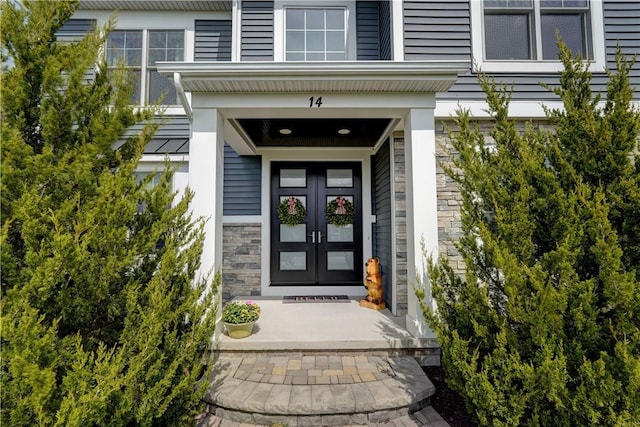 property entrance with french doors and stone siding