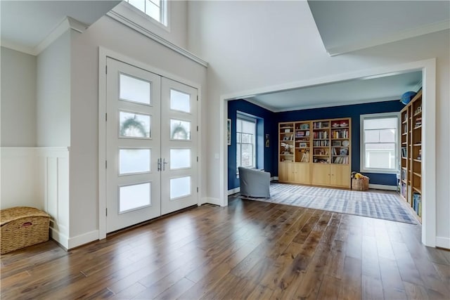 entrance foyer featuring french doors, crown molding, and hardwood / wood-style flooring