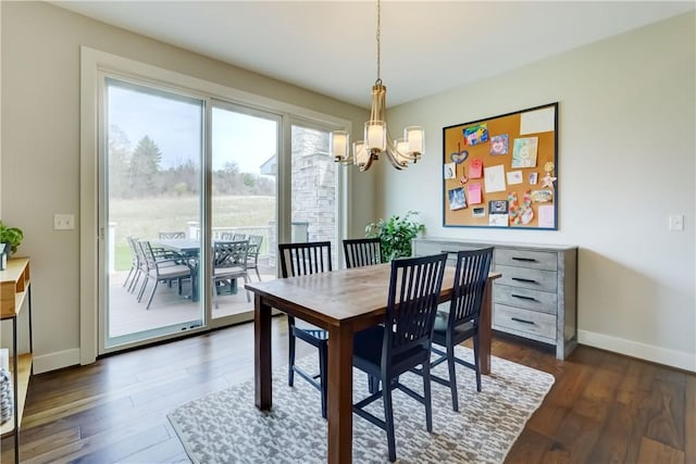 dining area featuring an inviting chandelier, baseboards, and dark wood-style flooring