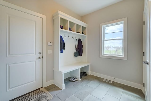 mudroom with visible vents, baseboards, and light tile patterned floors