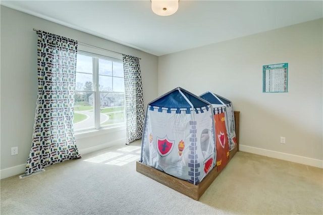 bedroom featuring baseboards and carpet