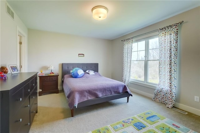 bedroom featuring visible vents, baseboards, and light carpet