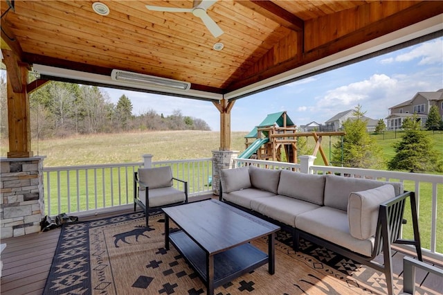 deck with an outdoor hangout area, a ceiling fan, a yard, and a playground