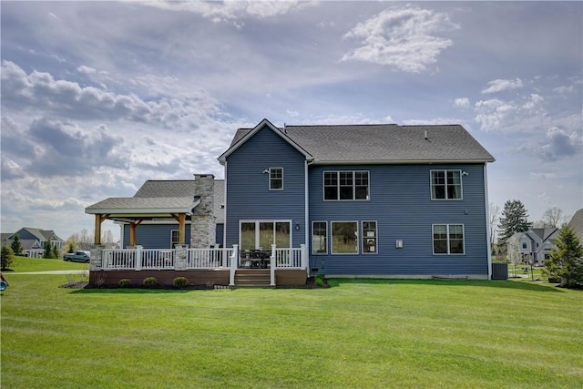 back of house featuring a yard, central AC, and a wooden deck