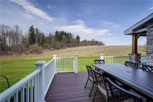 wooden deck with outdoor dining space and a yard