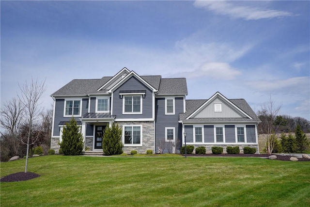 view of front of property with stone siding and a front lawn