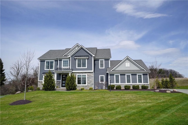 view of front of house featuring a front lawn and stone siding