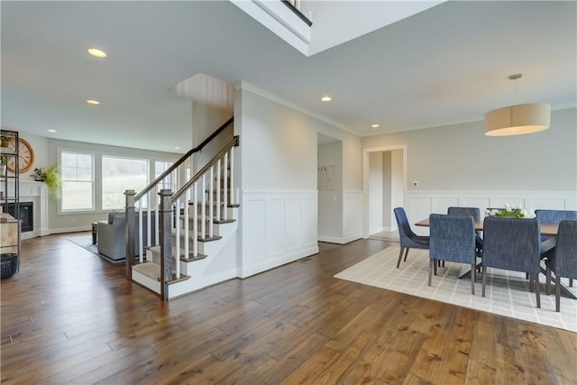 dining room featuring recessed lighting, a wainscoted wall, stairway, and wood finished floors
