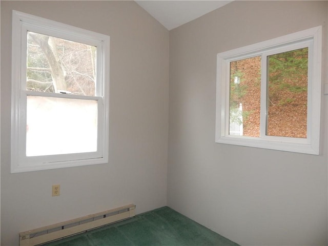 carpeted spare room with a baseboard heating unit and lofted ceiling