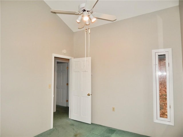 carpeted empty room with ceiling fan and high vaulted ceiling