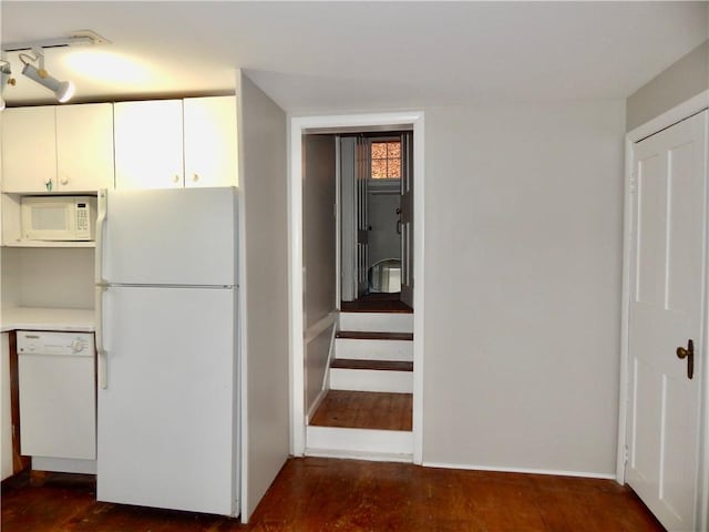 kitchen featuring light countertops, white cabinetry, dark wood finished floors, and white appliances