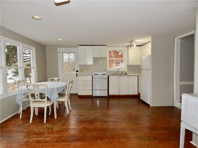 kitchen with light countertops, dark wood finished floors, white cabinets, and white appliances