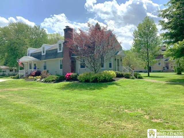 exterior space with a lawn and a chimney