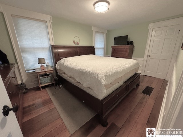 bedroom featuring dark wood-style flooring