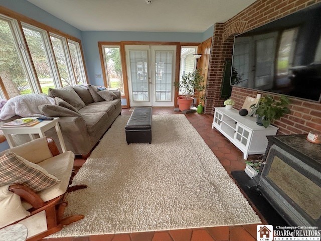 living area with french doors and brick wall