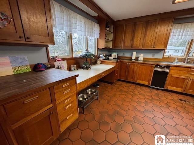 kitchen featuring open shelves, brown cabinetry, and a sink