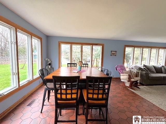 dining space with baseboards, tile patterned flooring, and visible vents
