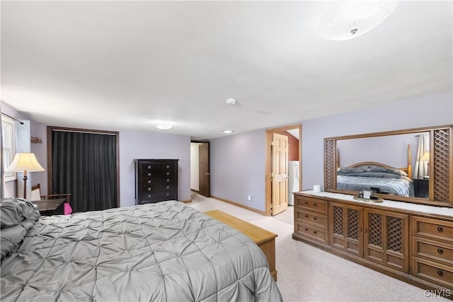 bedroom featuring freestanding refrigerator