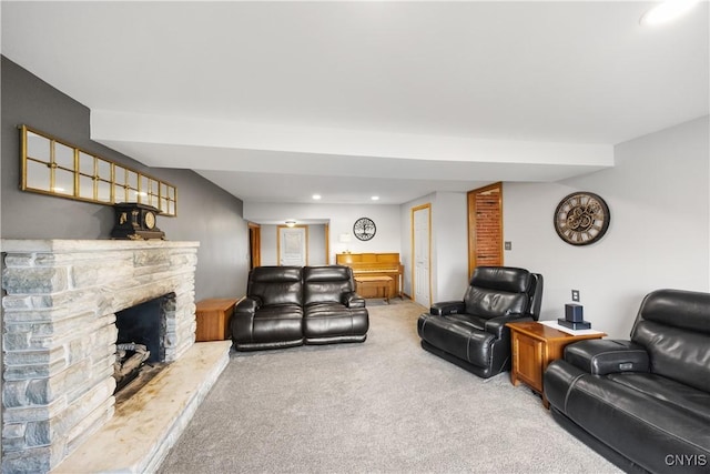 living area featuring recessed lighting, light colored carpet, and a fireplace