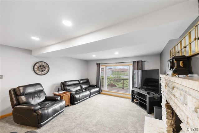 living room with carpet flooring, recessed lighting, and a stone fireplace