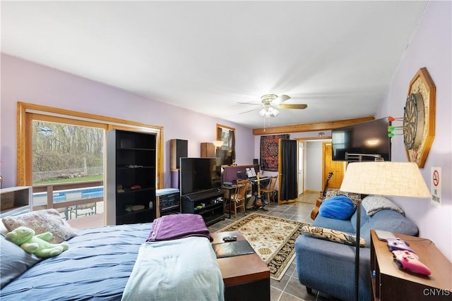 living area featuring a ceiling fan and tile patterned floors