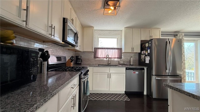 kitchen with decorative backsplash, stainless steel appliances, plenty of natural light, and a sink